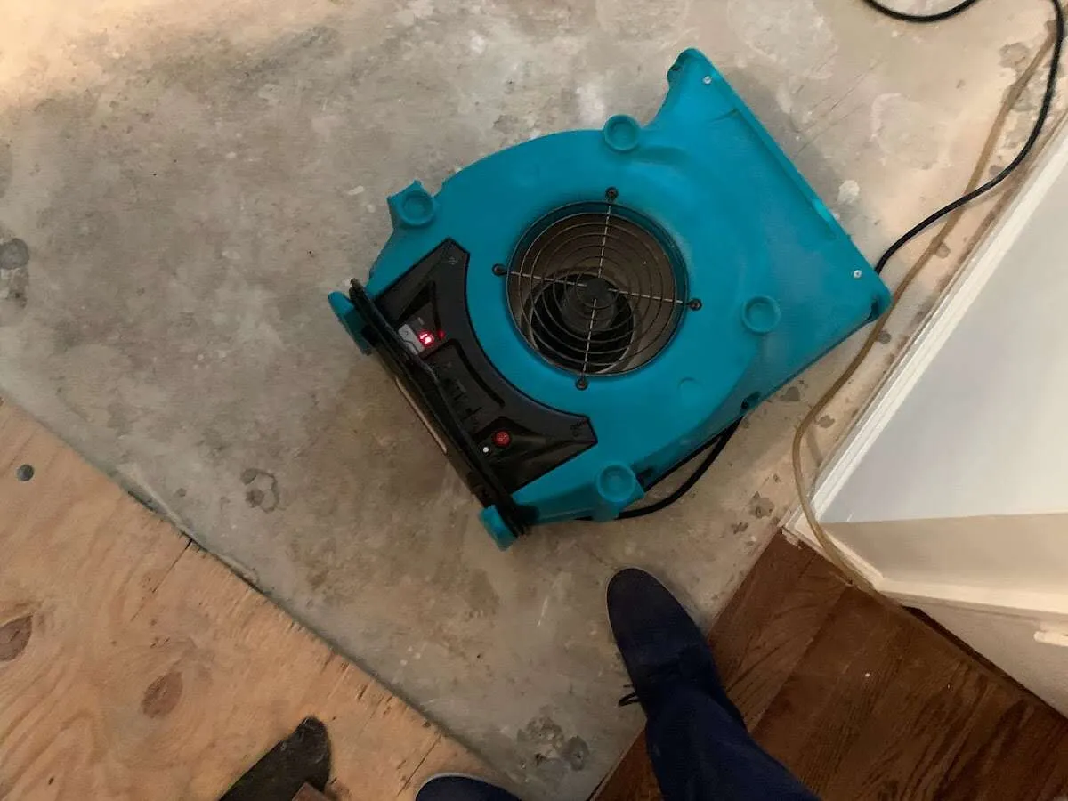 Air mover drying subfloor during Leak Detection & Repair in Stansbury Park